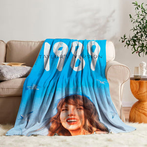 Taylor Swift 1989 album cover throw blanket on a cozy bed, perfect for dedicated Swifties and Taylor Swift fans.